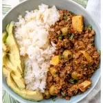 Picadillo served over rice with avocado