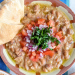 Ful medames with olive oil, tomatoes, onions parsley