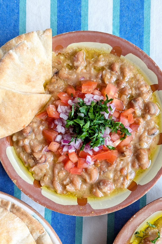 Ful medames with olive oil, tomatoes, onions parsley