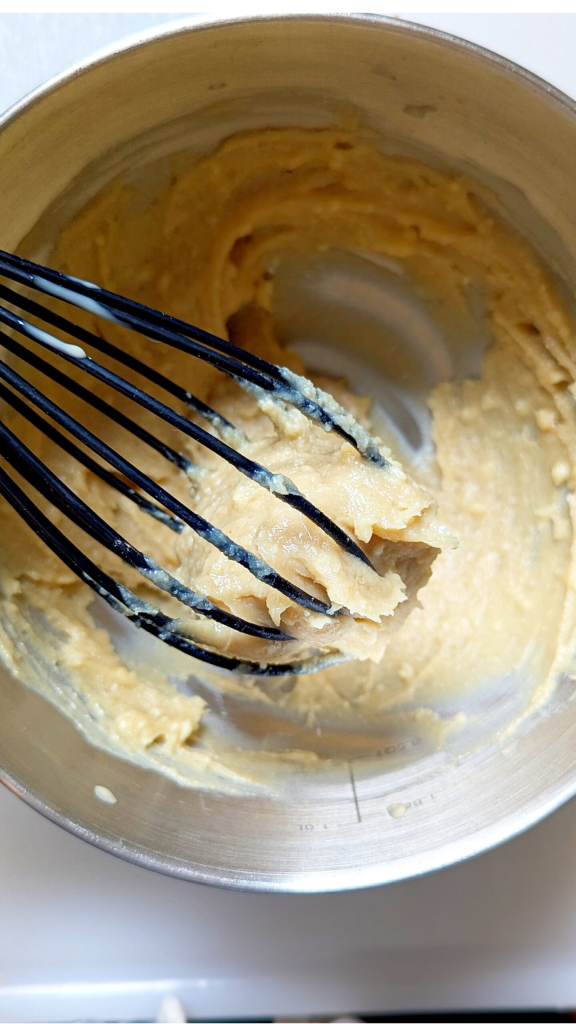 Whisking tahina with garlic, lemon, cumin and salt