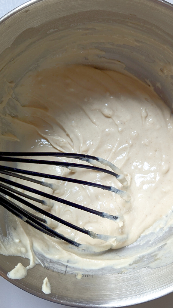 Add warm water to tahina and continue whisking